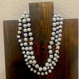 Brand New - Pearl faceted beads tied on a brown chord.